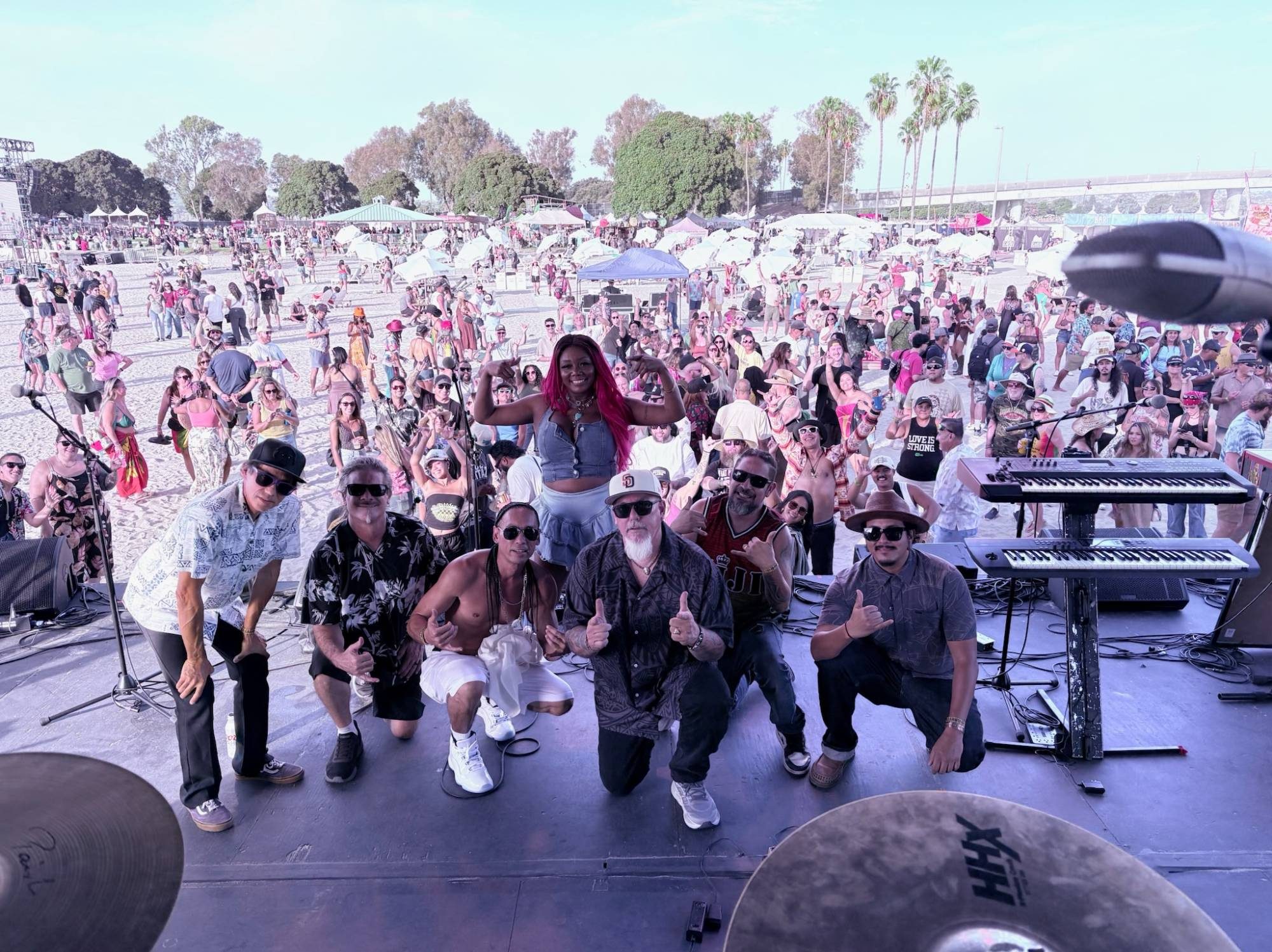 Kekoa and his band on stage at Mission Bayfest, with the crowd behind them
